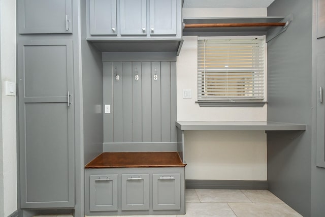 mudroom featuring light tile patterned floors and baseboards