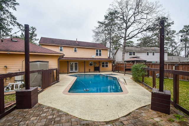 view of pool featuring a fenced in pool, an outbuilding, a gazebo, a patio area, and fence