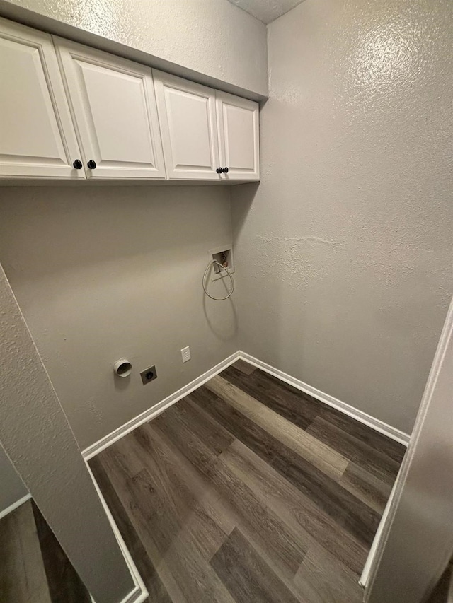 clothes washing area featuring cabinets, electric dryer hookup, hookup for a washing machine, and hardwood / wood-style floors