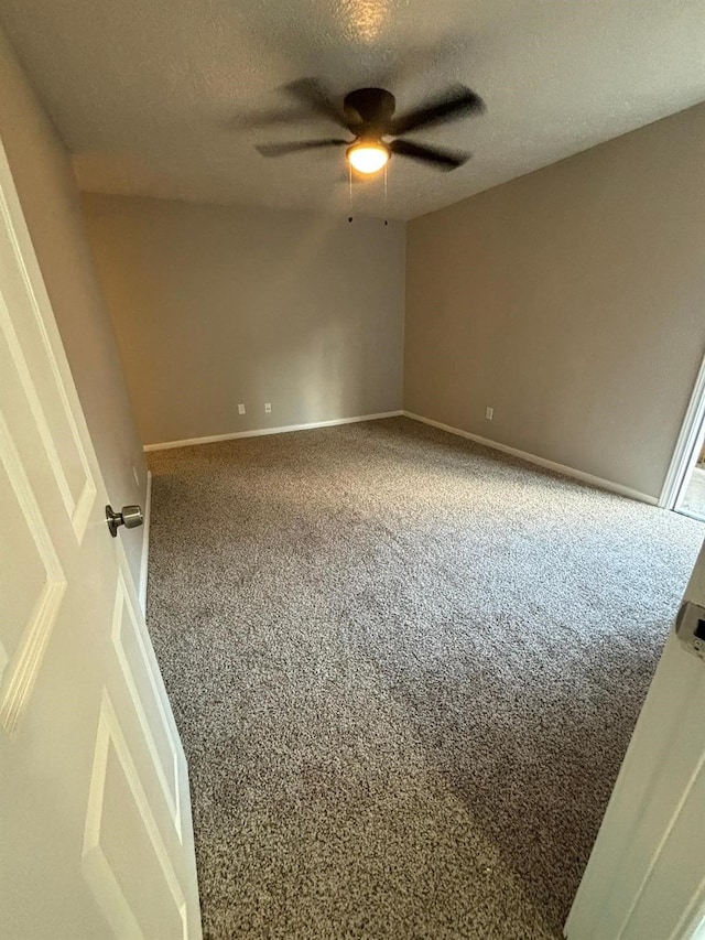 unfurnished room featuring ceiling fan, carpet, and a textured ceiling