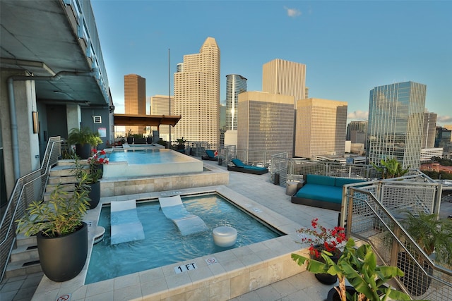 view of pool with an in ground hot tub and a patio