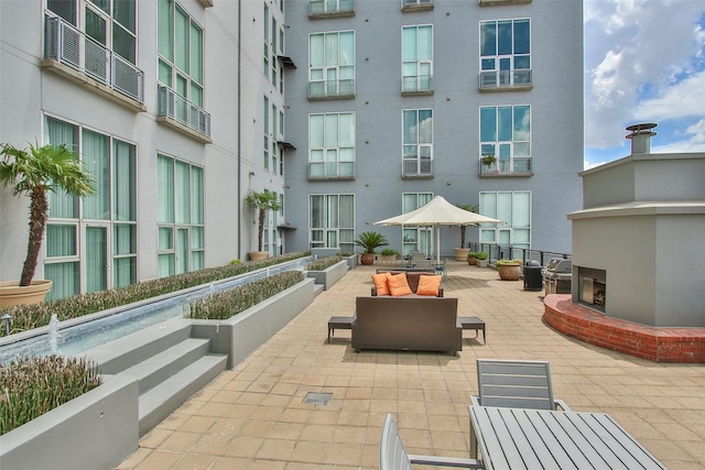 view of property's community with outdoor lounge area and a patio