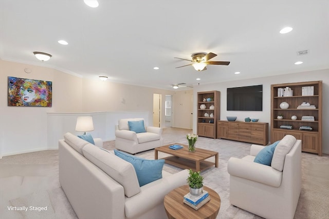 carpeted living room with crown molding, ceiling fan, and built in shelves