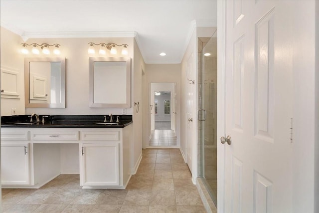 bathroom with crown molding, vanity, tile patterned flooring, and a shower with door