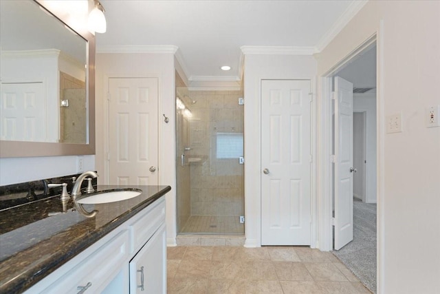 bathroom with vanity, tile patterned floors, ornamental molding, and a shower with door