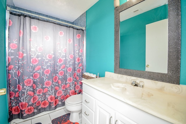 bathroom with vanity, walk in shower, tile patterned floors, and toilet