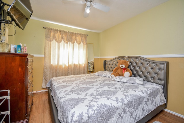 bedroom with ceiling fan and wood-type flooring