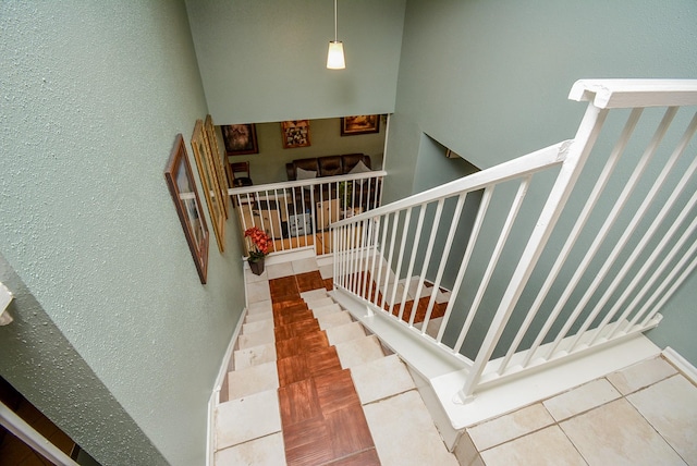 stairway with tile patterned floors