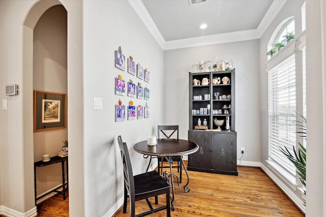 dining room featuring crown molding and wood-type flooring