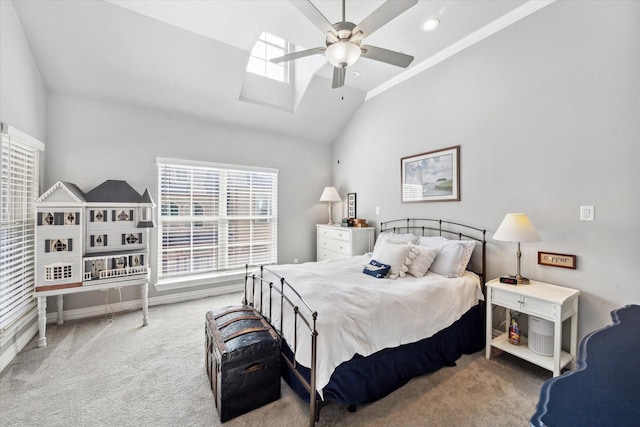 carpeted bedroom featuring ceiling fan and lofted ceiling with skylight