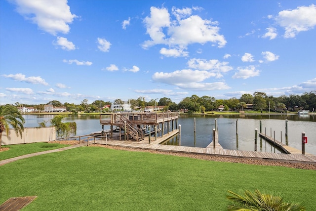 view of dock with a water view and a lawn