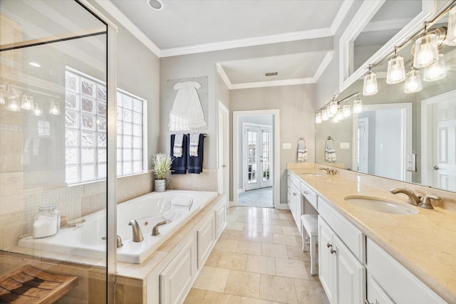 bathroom with a washtub, vanity, and crown molding