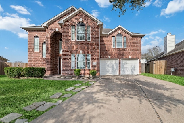 view of property with a garage and a front lawn