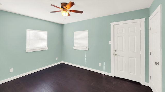 unfurnished room with ceiling fan and dark hardwood / wood-style flooring