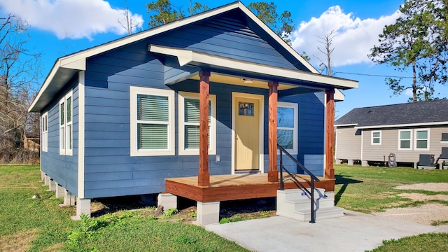 bungalow-style home with a front lawn