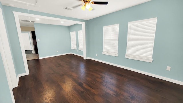 empty room featuring ceiling fan and dark hardwood / wood-style flooring