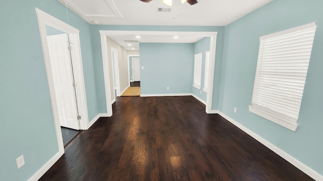 spare room with dark hardwood / wood-style floors and ceiling fan