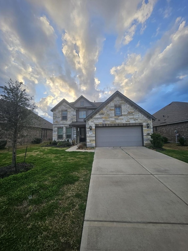 view of front of house with a yard and a garage