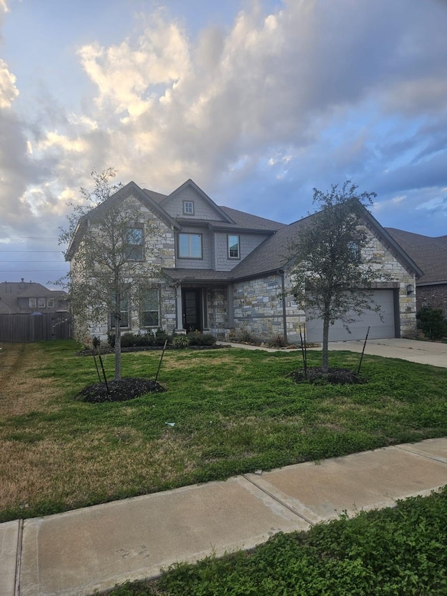 view of front of house featuring a garage and a front lawn