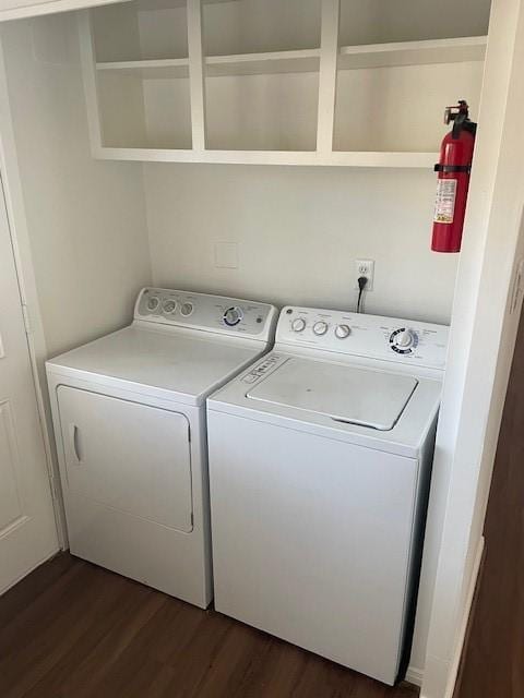 laundry area featuring dark wood-type flooring and washer and dryer