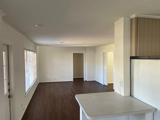 empty room with dark hardwood / wood-style flooring