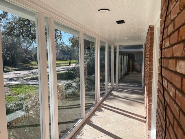 unfurnished sunroom featuring wood ceiling