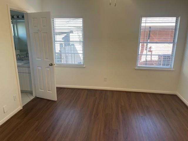 empty room with dark wood-type flooring