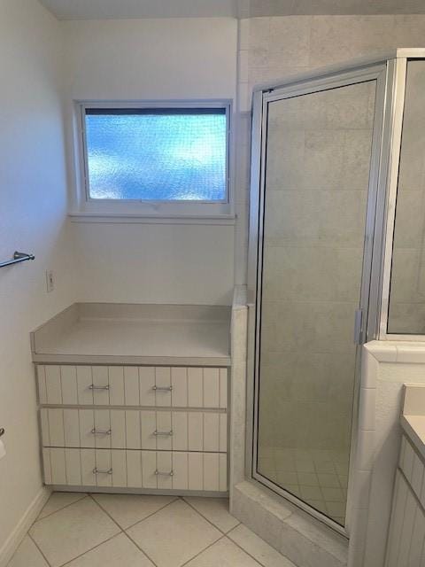 bathroom with vanity, tile patterned flooring, and a shower with door