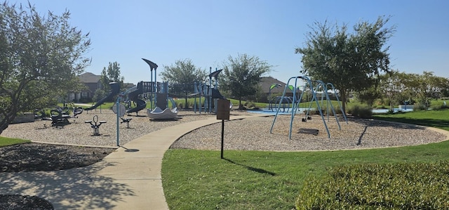 community jungle gym featuring a yard