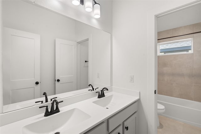 bathroom featuring tile patterned floors, toilet, double vanity, and a sink