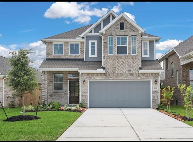 craftsman-style home featuring brick siding, a shingled roof, a garage, a front yard, and concrete driveway
