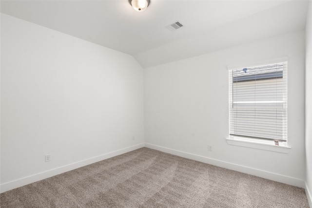 spare room featuring baseboards, visible vents, and carpet flooring