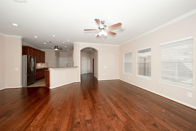 unfurnished living room with crown molding, dark hardwood / wood-style floors, and ceiling fan