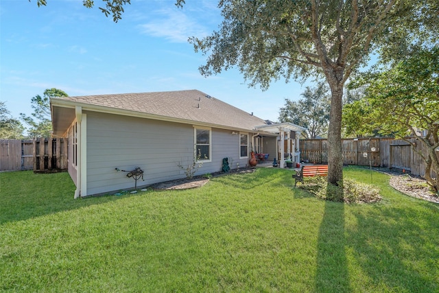 rear view of house with a pergola and a yard