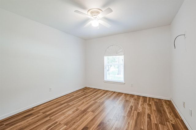 spare room featuring wood-type flooring and ceiling fan