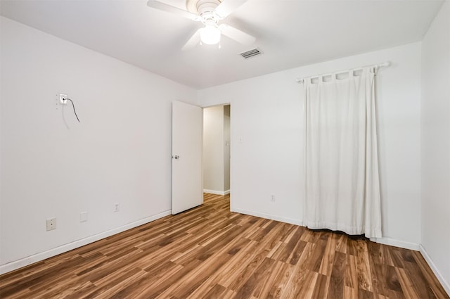 spare room with hardwood / wood-style floors and ceiling fan