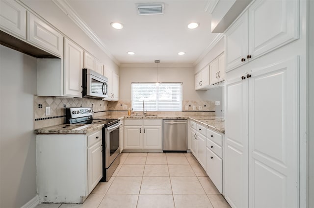 kitchen featuring light tile patterned flooring, decorative light fixtures, sink, white cabinets, and stainless steel appliances