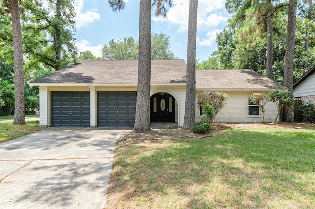 ranch-style house featuring a garage and a front yard