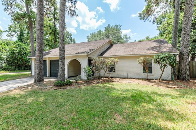 ranch-style house featuring a garage and a front lawn