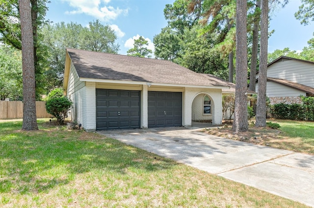 ranch-style home featuring a garage and a front yard