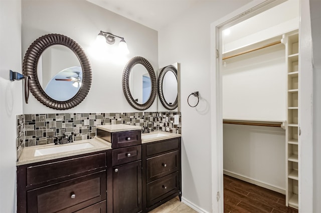 bathroom featuring tasteful backsplash, vanity, and hardwood / wood-style floors