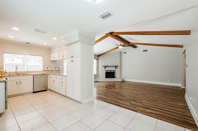 kitchen featuring white cabinetry, sink, a wealth of natural light, and stainless steel dishwasher