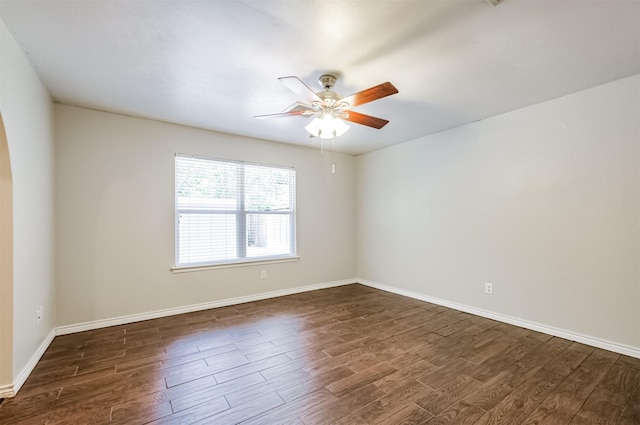 empty room with ceiling fan and dark hardwood / wood-style flooring