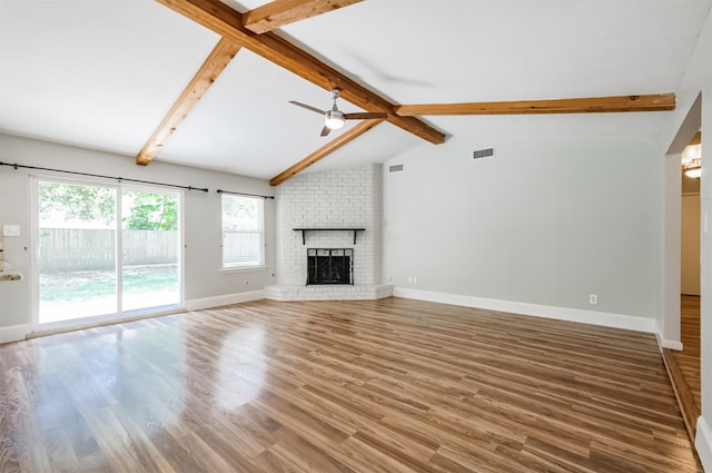 unfurnished living room featuring a brick fireplace, vaulted ceiling with beams, hardwood / wood-style floors, and ceiling fan