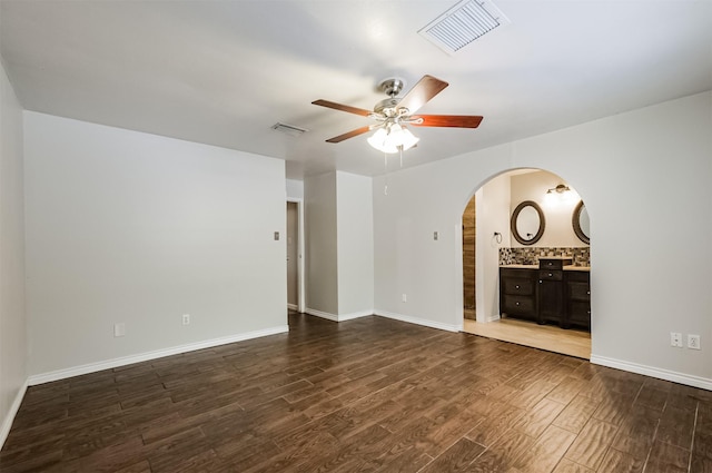 unfurnished living room with ceiling fan and dark hardwood / wood-style flooring