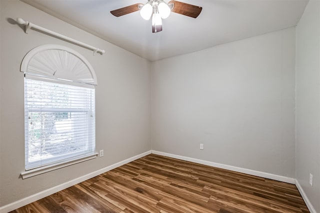 empty room featuring dark wood-type flooring and ceiling fan