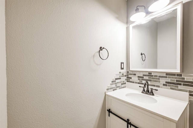 bathroom featuring vanity and backsplash