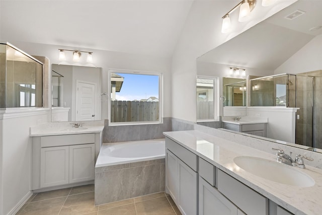 27603 Beachside Arbor Dr, Katy, TX 77493 - bathroom with lofted ceiling, a stall shower, tile patterned flooring, a bath, and two vanities