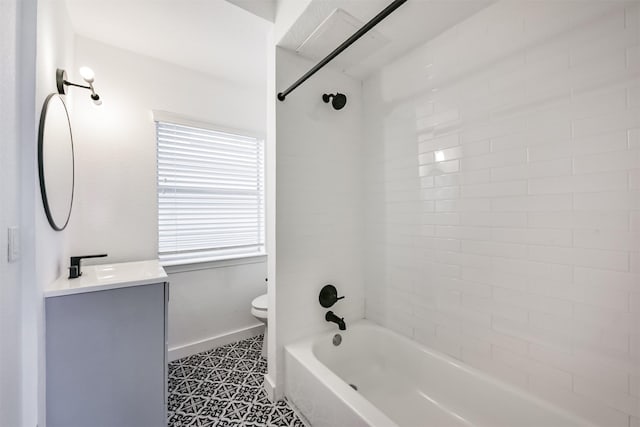 bathroom with toilet, baseboards, tub / shower combination, and vanity