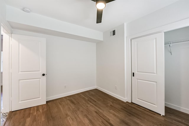 unfurnished bedroom with ceiling fan, visible vents, baseboards, a closet, and dark wood finished floors